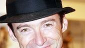 Jackman uses a sleek fedora to turn his backstage casual getup into a fashion 