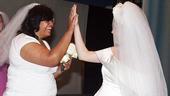 Brides-to-be Lauren Hopkins Sheridan and Sophie Sheridan(er, Brandi Burkhardt) share a high-five.