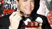 Brent Barrett, who stars as slick lawyer Billy Flynn, pleads no contest to a slice of anniversary cake.