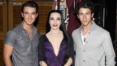 Morticia in the middle! Tony winner Bebe Neuwirth joins the Jonas boys.