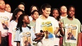 Idina Menzel holds hands with the young ladies who experienced a week of musical theater magic thanks to the Tony winner and her husband, Taye Diggs.