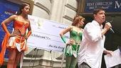 McGrath gets some help with the raffle from Spamalot showgirls Ariel Reid and Jennifer Frankel.